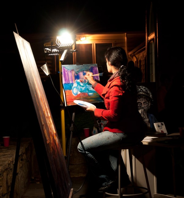Artist Tiffany Roman paints during Art After Dark